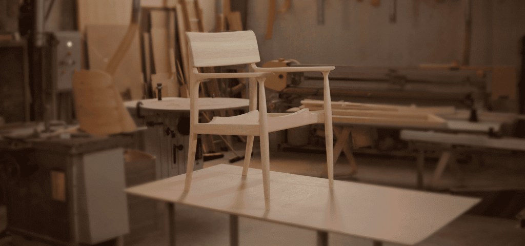 Close-up of a wooden chair being crafted in a Brazilian furniture factory.