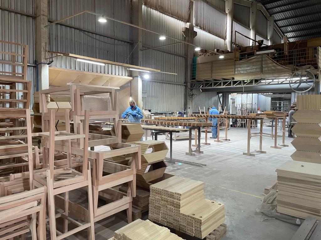Furniture manufacturing in Brazil showing wooden chair frame production in a Brazilian factory
